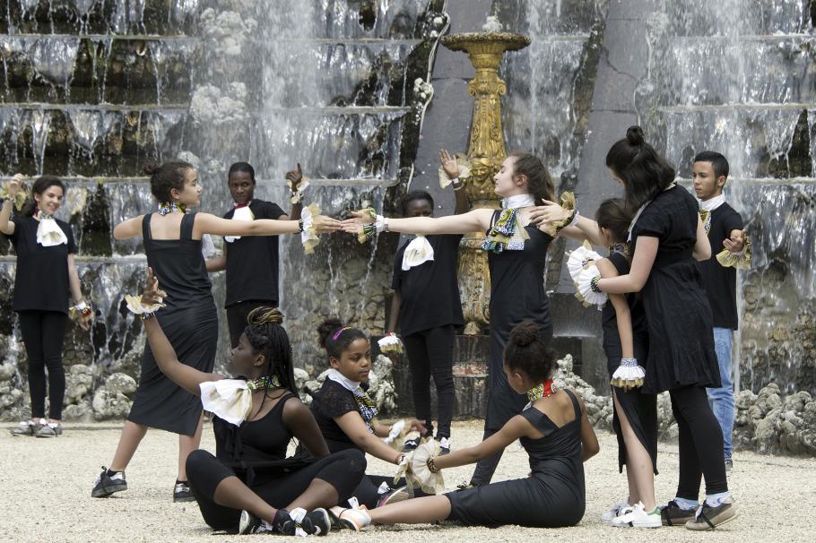 dancers in front of a fountain